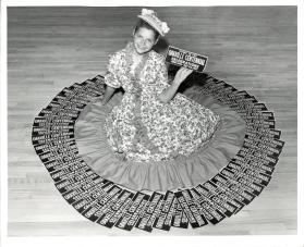 Girl in Victorian dress and Oakville Centennial bumper stickers