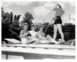 Four girls on deck of a boat