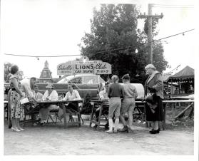 Selling tickets for the Lion's Club Car Draw during Centennial Celebrations