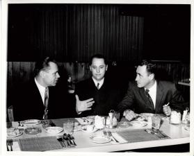 Three Men sitting in a Restaurant