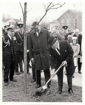 Hon. Earl Rowe Planting "Chisholm Oak Tree" outside the Centennial Center with James W. Snow
