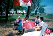 People at Coronation park during the Oakville Waterfront Festival filling out Speak Out!... Canada... Pensons-y! Ballot entries
