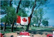 Canada Flag hanging between two trees at Coronation Park during the Oakville Waterfront Festival in 1998